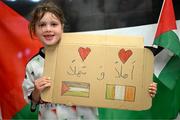 12 May 2024; Nysaa Eldin, age 6, from Phibsborough, waits to greet the Palesinte players on their on arrival at Dublin Airport as the Palestine women's national football team arrive in Ireland for an International Solidarity Match against Bohemians to be played on Wednesday at Dalymount Park in Dublin. Photo by Stephen McCarthy/Sportsfile