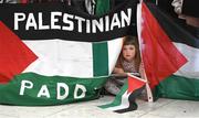 12 May 2024; 4-year-old Riadh McCafferty, from Glasnevin, awaits the arrival at Dublin Airport of the Palestine women's national football team. The team arrived in Ireland for an International Solidarity Match against Bohemians to be played on Wednesday at Dalymount Park in Dublin. Photo by Stephen McCarthy/Sportsfile