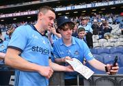 12 May 2024; Con O'Callaghan of Dublin takes a photo with a Dublin supporter after the Leinster GAA Football Senior Championship final match between Dublin and Louth at Croke Park in Dublin. Photo by Ben McShane/Sportsfile