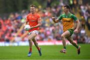 12 May 2024; Rian O'Neill of Armagh in action against Michael Langan of Donegal during the Ulster GAA Football Senior Championship final match between Armagh and Donegal at St Tiernach's Park in Clones, Monaghan. Photo by Ramsey Cardy/Sportsfile