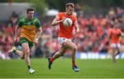 12 May 2024; Rian O'Neill of Armagh in action against Eoghán Bán Gallagher of Donegal during the Ulster GAA Football Senior Championship final match between Armagh and Donegal at St Tiernach's Park in Clones, Monaghan. Photo by Ramsey Cardy/Sportsfile