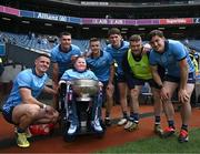 12 May 2024; Dublin supporter Cathal Briscoe with the Delaney Cup and Dublin players, from left, Brian Howard, Theo Clancy, Eoin Murchan, Michael Fitzsimons, Cian O’Connor and Killian McGinnis after their side's victory in the Leinster GAA Football Senior Championship final match between Dublin and Louth at Croke Park in Dublin. Photo by Harry Murphy/Sportsfile