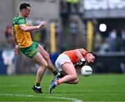 12 May 2024; Jason McGee of Donegal fouls Aaron  McKay of Armagh, for which he was shown a yellow card, during the Ulster GAA Football Senior Championship final match between Armagh and Donegal at St Tiernach's Park in Clones, Monaghan. Photo by Piaras Ó Mídheach/Sportsfile