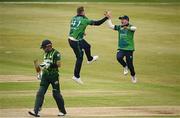 12 May 2024; Graham Hume of Ireland, left, celebrates with teammate Curtis Campher after taking the wicket of Pakistan's Babar Azam during match two of the Floki Men's T20 International Series between Ireland and Pakistan at Castle Avenue Cricket Ground in Dublin. Photo by Seb Daly/Sportsfile