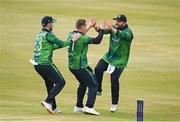 12 May 2024; Graham Hume of Ireland, centre, celebrates with teammates Paul Stirling, right, and Andrew Balbirnie after taking the wicket of Pakistan's Babar Azam during match two of the Floki Men's T20 International Series between Ireland and Pakistan at Castle Avenue Cricket Ground in Dublin. Photo by Seb Daly/Sportsfile