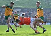 12 May 2024; Jarly Óg Burns of Armagh in action against Daire O Baoill of Donegal, left, and Jason McGee of Donegal during the Ulster GAA Football Senior Championship final match between Armagh and Donegal at St Tiernach's Park in Clones, Monaghan. Photo by Piaras Ó Mídheach/Sportsfile