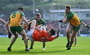 12 May 2024; Jarly Óg Burns of Armagh in action against Donegal players, from left, Caolan McGonagle, Jeaic MacCeallbhuí and Jason McGee during the Ulster GAA Football Senior Championship final match between Armagh and Donegal at St Tiernach's Park in Clones, Monaghan. Photo by Piaras Ó Mídheach/Sportsfile