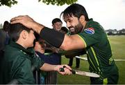 12 May 2024; Mohammad Rizwan of Pakistan with a supporter after match two of the Floki Men's T20 International Series between Ireland and Pakistan at Castle Avenue Cricket Ground in Dublin. Photo by Seb Daly/Sportsfile