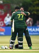 12 May 2024; Pakistan players Mohammad Rizwan, right, and Azam Khan after their side's victory during match two of the Floki Men's T20 International Series between Ireland and Pakistan at Castle Avenue Cricket Ground in Dublin. Photo by Seb Daly/Sportsfile