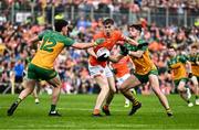 12 May 2024; Andrew Murnin of Armagh in action against Daire O Baoill of Donegal, 12, and Brendan McCole of Donegal during the Ulster GAA Football Senior Championship final match between Armagh and Donegal at St Tiernach's Park in Clones, Monaghan. Photo by Piaras Ó Mídheach/Sportsfile