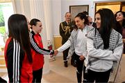 13 May 2024; Bohemians players Rachael Kelly, left, and Savannah Kane with Palestine players Jeniver Shattara and Mira Natour, right, on arrival for The President of Ireland Michael D Higgins to receive representatives of the Palestinian Football Association and Bohemian Football Club at Áras an Uachtaráin in Dublin. Palestine women's national football team are in Ireland for an International Solidarity Match against Bohemians women's team to be played on Wednesday, May 15, at Dalymount Park in Dublin. Photo by Stephen McCarthy/Sportsfile
