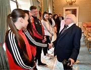 13 May 2024; The President of Ireland Michael D Higgins with Bohemians goalkeeper Rachael Kelly, accompanied by team-mate Savannah Kane and manager Ken Kiernan during a courtesy call with representatives of the Palestinian Football Association and Bohemian Football Club at Áras an Uachtaráin in Dublin. Palestine women's national football team are in Ireland for an International Solidarity Match against Bohemians women's team to be played on Wednesday, May 15, at Dalymount Park in Dublin. Photo by Stephen McCarthy/Sportsfile