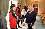 13 May 2024; The President of Ireland Michael D Higgins with Bohemians' Savannah Kane during a courtesy call with representatives of the Palestinian Football Association and Bohemian Football Club at Áras an Uachtaráin in Dublin. Palestine women's national football team are in Ireland for an International Solidarity Match against Bohemians women's team to be played on Wednesday, May 15, at Dalymount Park in Dublin. Photo by Stephen McCarthy/Sportsfile