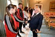 13 May 2024; The President of Ireland Michael D Higgins with Bohemians goalkeeper Rachael Kelly, accompanied by team-mate Savannah Kane, left, and manager Ken Kiernan during a courtesy call with representatives of the Palestinian Football Association and Bohemian Football Club at Áras an Uachtaráin in Dublin. Palestine women's national football team are in Ireland for an International Solidarity Match against Bohemians women's team to be played on Wednesday, May 15, at Dalymount Park in Dublin. Photo by Stephen McCarthy/Sportsfile