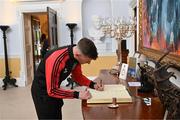 13 May 2024; Bohemians manager Ken Kiernan signs the guest book on arrival for The President of Ireland Michael D Higgins to receive representatives of the Palestinian Football Association and Bohemian Football Club at Áras an Uachtaráin in Dublin. Palestine women's national football team are in Ireland for an International Solidarity Match against Bohemians women's team to be played on Wednesday, May 15, at Dalymount Park in Dublin. Photo by Stephen McCarthy/Sportsfile