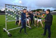 13 May 2024; Kerry players celebrate with their manager Wayne Quillinan as he is interviewed by Micheal O Domhnaill of TG4 after the Electric Ireland Munster GAA Football Minor Championship Final match between Cork and Kerry at Páirc Ui Rinn in Cork. Photo by Brendan Moran/Sportsfile