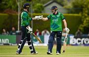 14 May 2024; Lorcan Tucker of Ireland, right, and team-mate Andrew Balbirnie bump fists during match three of the Floki Men's T20 International Series between Ireland and Pakistan at Castle Avenue Cricket Ground in Dublin. Photo by Sam Barnes/Sportsfile