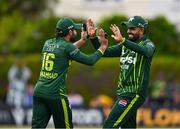 14 May 2024; Mohammad Rizwan of Pakistan, left, and team-mate Babar Azam celebrate the wicket of Andrew Balbirnie of Ireland during match three of the Floki Men's T20 International Series between Ireland and Pakistan at Castle Avenue Cricket Ground in Dublin. Photo by Sam Barnes/Sportsfile