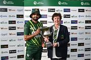 14 May 2024; Pakistan captain Babar Azam is presented with the trophy by Cricket Ireland President Stella Downes after his side's victory  in match three of the Floki Men's T20 International Series between Ireland and Pakistan at Castle Avenue Cricket Ground in Dublin. Photo by Sam Barnes/Sportsfile