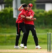 16 May 2024; Zubair Hassan Khan of Munster Reds celebrates with teammate Joshua Manley after taking the wicket of Tim Tector of Leinster Lightning during the Inter-Provincial IP20 Trophy match between Leinster Lightning and Munster Reds at Sydney Parade, Sandymount in Dublin. Photo by Harry Murphy/Sportsfile