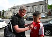 17 May 2024; St Patrick's Athletic manager Stephen Kenny signs an autograph for supporter Mason Rexhepagiqi before the SSE Airtricity Men's Premier Division match between St Patrick's Athletic and Derry City at Richmond Park in Dublin. Photo by Stephen McCarthy/Sportsfile