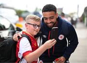 17 May 2024; Jake Mulraney of St Patrick's Athletic poses for a photograph with a supporter before the SSE Airtricity Men's Premier Division match between St Patrick's Athletic and Derry City at Richmond Park in Dublin. Photo by Stephen McCarthy/Sportsfile