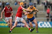 17 May 2024; Shane Woods of Clare is tackled by Cillian Tobin of Cork during the oneills.com Munster GAA U20 Hurling Championship semi-final match between Clare and Cork at Cusack Park in Ennis, Clare. Photo by Brendan Moran/Sportsfile