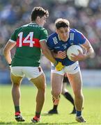 18 May 2024; Oisin Kiernan of Cavan in action against Tommy Conroy of Mayo during the GAA Football All-Ireland Senior Championship Round 1 match between Mayo and Cavan at Hastings Insurance MacHale Park in Castlebar, Mayo. Photo by Stephen Marken/Sportsfile