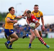 18 May 2024; Conor Corbett of Cork in action against Alan Sweeney, left, and Darragh Bohannon of Clare during the GAA Football All-Ireland Senior Championship Round 1 match between Clare and Cork at Cusack Park in Ennis, Clare. Photo by Ray McManus/Sportsfile