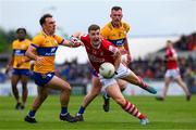 18 May 2024; Conor Corbett of Cork in action against Alan Sweeney, left, and Darragh Bohannon of Clare during the GAA Football All-Ireland Senior Championship Round 1 match between Clare and Cork at Cusack Park in Ennis, Clare. Photo by Ray McManus/Sportsfile