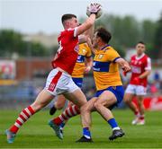18 May 2024; Conor Corbett of Cork is tackled by Alan Sweeney of Clare during the GAA Football All-Ireland Senior Championship Round 1 match between Clare and Cork at Cusack Park in Ennis, Clare. Photo by Ray McManus/Sportsfile