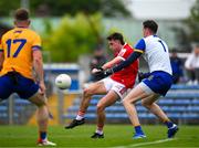 18 May 2024; Chris Óg Jones of Cork kicks a wide, under pressure from Clare goalkeeper Stephen Ryan, during the GAA Football All-Ireland Senior Championship Round 1 match between Clare and Cork at Cusack Park in Ennis, Clare. Photo by Ray McManus/Sportsfile