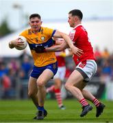 18 May 2024; Brian McNamara of Clare is tackled by Maurice Shanley of Cork during the GAA Football All-Ireland Senior Championship Round 1 match between Clare and Cork at Cusack Park in Ennis, Clare. Photo by Ray McManus/Sportsfile