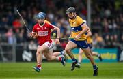 17 May 2024; Niall O'Farrell of Clare in action against Darragh O’Sullivan of Cork during the oneills.com Munster GAA U20 Hurling Championship semi-final match between Clare and Cork at Cusack Park in Ennis, Clare. Photo by Brendan Moran/Sportsfile