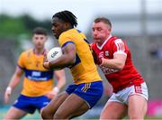 18 May 2024; Ikem Ugweru of Clare in action against Brian Hurley of Cork during the GAA Football All-Ireland Senior Championship Round 1 match between Clare and Cork at Cusack Park in Ennis, Clare. Photo by Ray McManus/Sportsfile