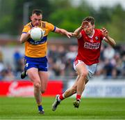 18 May 2024; Darragh Bohannon of Clare in action against Paul Walsh of Cork during the GAA Football All-Ireland Senior Championship Round 1 match between Clare and Cork at Cusack Park in Ennis, Clare. Photo by Ray McManus/Sportsfile