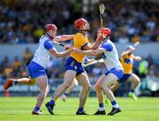 19 May 2024; Peter Duggan of Clare is tackled by Tadhg de Burca, right, and Calum Lyons of Waterford during the Munster GAA Hurling Senior Championship Round 4 match between Clare and Waterford at Cusack Park in Ennis, Clare. Photo by Ray McManus/Sportsfile