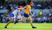 19 May 2024; Peter Duggan of Clare is tackled by Calum Lyons of Waterford during the Munster GAA Hurling Senior Championship Round 4 match between Clare and Waterford at Cusack Park in Ennis, Clare. Photo by Ray McManus/Sportsfile