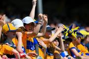 19 May 2024; Supporters on the North terrace celebrate a Clare score during the Munster GAA Hurling Senior Championship Round 4 match between Clare and Waterford at Cusack Park in Ennis, Clare. Photo by Ray McManus/Sportsfile