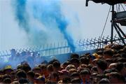 19 May 2024; A blue flare on the West terrace during the Munster GAA Hurling Senior Championship Round 4 match between Clare and Waterford at Cusack Park in Ennis, Clare. Photo by Ray McManus/Sportsfile