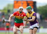 19 May 2024; Matthew O'Hanlon of Wexford in action against James Doyle of Carlow during the Leinster GAA Hurling Senior Championship Round 4 match between Carlow and Wexford at Netwatch Cullen Park in Carlow. Photo by Michael P Ryan/Sportsfile