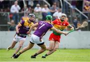 19 May 2024; James Doyle of Carlow in action against Eoin Ryan, left, and Matthew O'Hanlon of Wexford during the Leinster GAA Hurling Senior Championship Round 4 match between Carlow and Wexford at Netwatch Cullen Park in Carlow. Photo by Michael P Ryan/Sportsfile