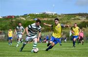 19 May 2024; Corey McBride of Cockhill Celtic in action against Chris McFadden of Ayrfield United during the Sports Direct Men’s FAI Cup First Round match between Cockhill Celtic and Ayrfield United at Charlie O'Donnell Sports Grounds in Buncrana, Donegal. Photo by Ramsey Cardy/Sportsfile