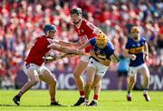 19 May 2024; Mark Kehoe of Tipperary is tackled by Sean O'Donoghue, left, and Eoin Downey of Cork during the Munster GAA Hurling Senior Championship Round 4 match between Tipperary and Cork at FBD Semple Stadium in Thurles, Tipperary. Photo by Brendan Moran/Sportsfile