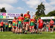 19 May 2024; Kevin McDonald of Carlow with mascot Kyle Lillis run out before the Leinster GAA Hurling Senior Championship Round 4 match between Carlow and Wexford at Netwatch Cullen Park in Carlow. Photo by Michael P Ryan/Sportsfile