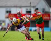 19 May 2024; Cathal Dunbar of Wexford in action against Jack McCullagh, left, and Tony Lawlor of Carlow during the Leinster GAA Hurling Senior Championship Round 4 match between Carlow and Wexford at Netwatch Cullen Park in Carlow. Photo by Michael P Ryan/Sportsfile