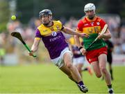 19 May 2024; Liam 0g McGovern of Wexford in action against Kevin McDonald of Carlow during the Leinster GAA Hurling Senior Championship Round 4 match between Carlow and Wexford at Netwatch Cullen Park in Carlow. Photo by Michael P Ryan/Sportsfile