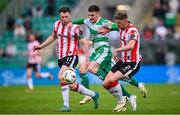20 May 2024; Trevor Clarke of Shamrock Rovers in action against Cameron McJannet, left, and Ronan Boyce of Derry City during the SSE Airtricity Men's Premier Division match between Shamrock Rovers and Derry City at Tallaght Stadium in Dublin. Photo by Ramsey Cardy/Sportsfile