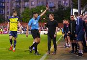 20 May 2024; Shelbourne goalkeeping coach Paul Skinner, right, is shown a red card by referee Rob Hennessy as Shelbourne manager Damien Duff looks on during the SSE Airtricity Men's Premier Division match between St Patrick's Athletic and Shelbourne at Richmond Park in Dublin. Photo by Stephen McCarthy/Sportsfile