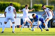 23 May 2024; Rowan McDonald of Waterford in action against Darragh Markey, left, and Adam Foley of Drogheda United during the SSE Airtricity Men's Premier Division match between Waterford and Drogheda United at the Regional Sports Centre in Waterford. Photo by Tyler Miller/Sportsfile